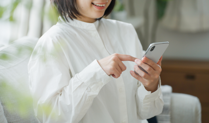 スマホで予約をしている女性